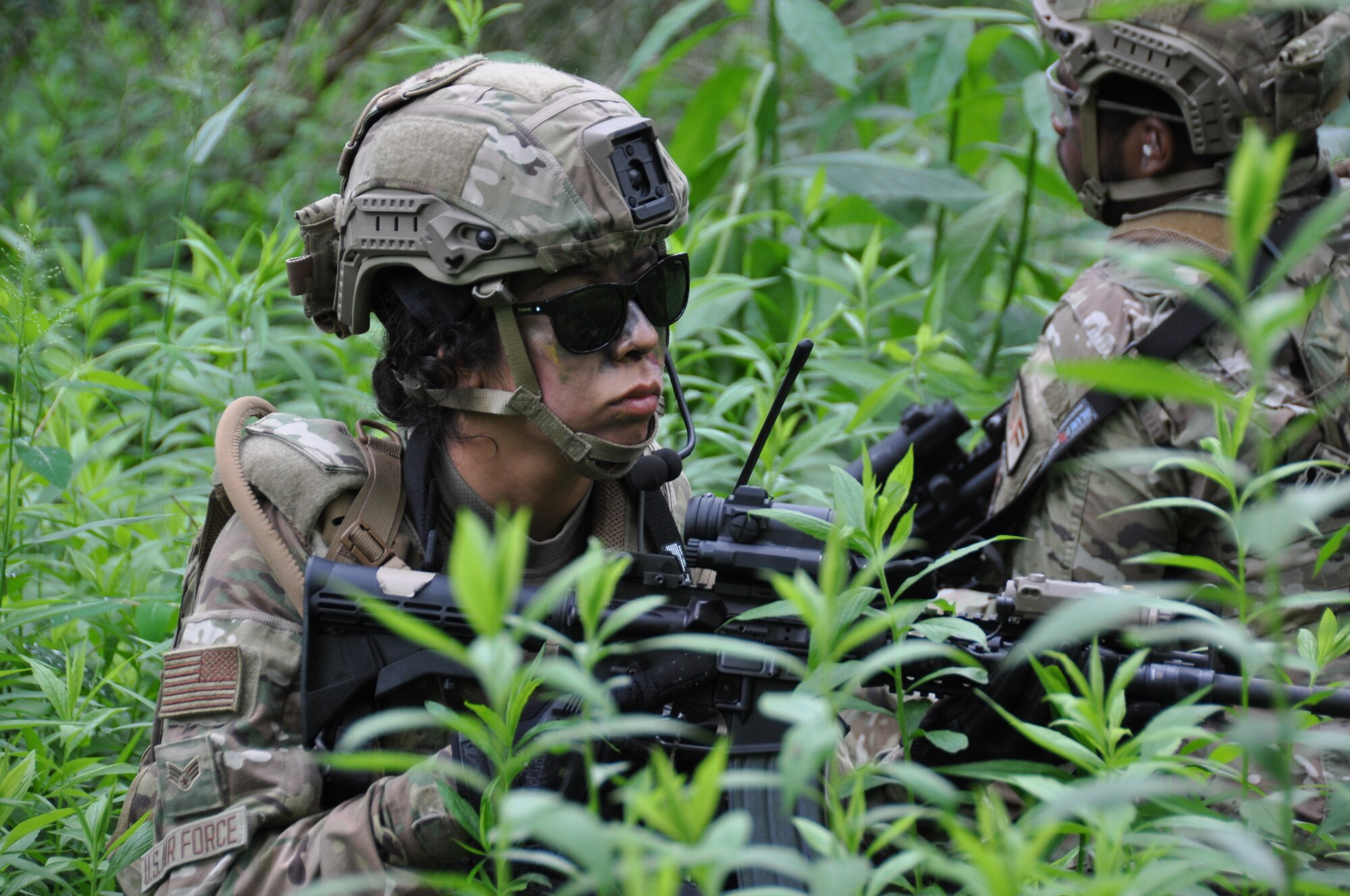 A member of the 445th Security Forces Squadron moves through the woods as part of a field training exercise