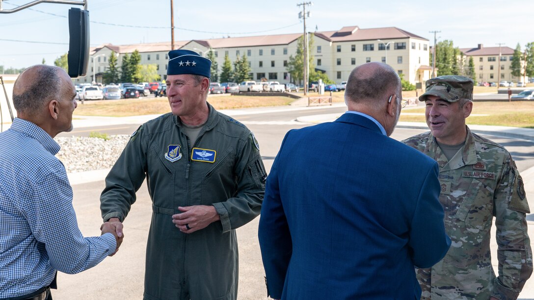 A photo of Lt. Gen. David Krumm greeting civic leaders with Chief Master Sgt. Kristopher Berg