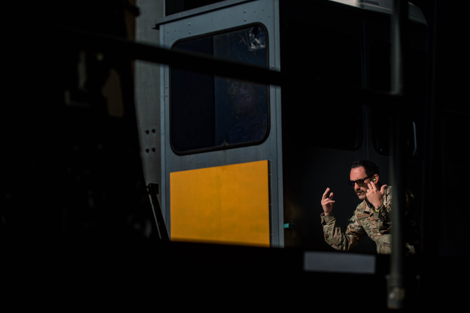 Airman marshals a vehicle