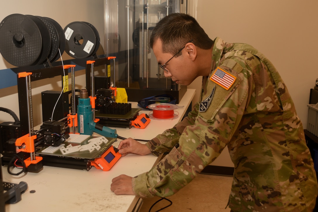 U.S. Space Force 2nd Lt. Kevin Tran, 1st Space Analysis Squadron developmental engineer, Wright Patterson Air Force Base, Ohio, adjusts the configuration of a 3D printer, June 29, 2022, at Patrick Space Force Base, Fla. Tran is temporarily assigned to Space Launch Delta 45’s innovation center, The Forge, as part of Project Arc. (U.S. Space Force photo by Tech. Sgt. James Hodgman)