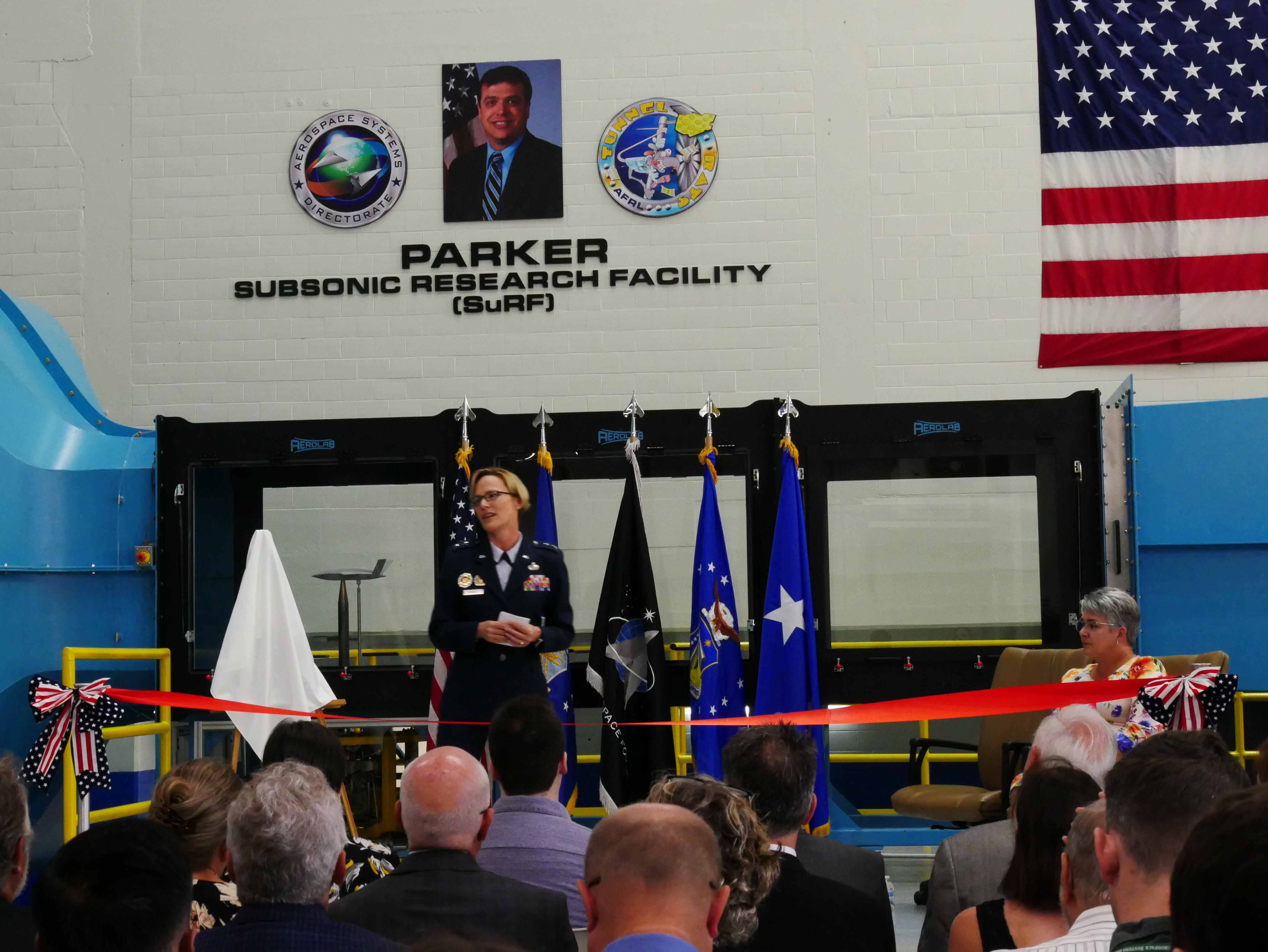Air Force Research Laboratory Commander Maj. Gen. Heather Pringle delivers opening remarks during a ribbon-cutting and dedication ceremony for the lab’s newest wind tunnel, the Parker Subsonic Research Facility, or SuRF, at Wright-Patterson Air Force Base, Ohio, July 7, 2022. The facility is named after Dr. Greg Parker, a beloved member of AFRL's Aerospace Systems Directorate, who died after a long battle with cancer. SuRF is a low-speed wind tunnel used to evaluate prototype models including 3D-printed components that allows engineers to validate new aircraft designs. (U.S. Air Force photo / Kenneth McNulty)