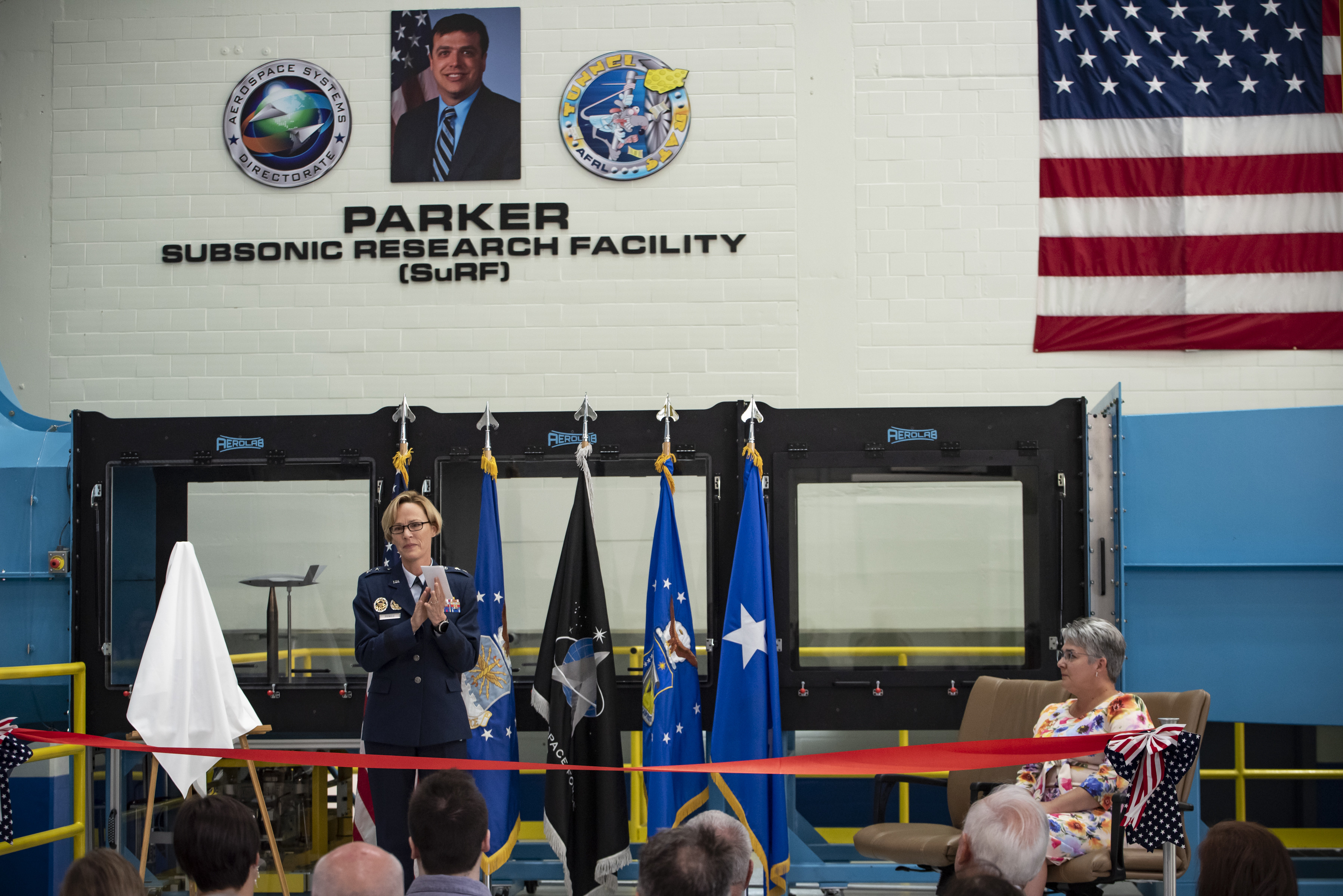 Air Force Research Laboratory Commander Maj. Gen. Heather Pringle delivers opening remarks during a ribbon-cutting and dedication ceremony for the lab’s newest wind tunnel, the Parker Subsonic Research Facility, or SuRF, at Wright-Patterson Air Force Base, Ohio, July 7, 2022. The facility is named after Dr. Greg Parker, a beloved member of AFRL's Aerospace Systems Directorate, who died after a long battle with cancer. SuRF is a low-speed wind tunnel used to evaluate prototype models including 3D-printed components that allows engineers to validate new aircraft designs. (U.S. Air Force photo / Rick Eldridge)