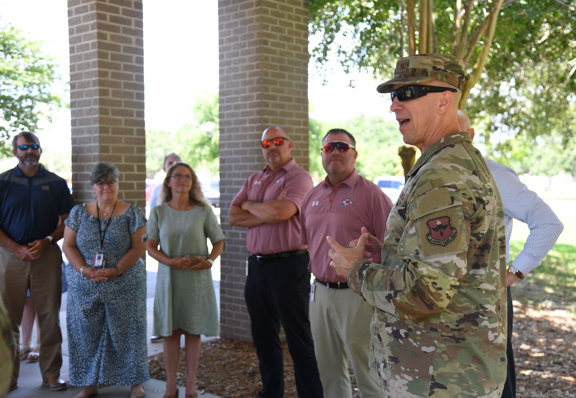 U.S. Air Force Col. William Hunter, 81st Training Wing commander, provides welcoming remarks to members of the Biloxi and Jackson County School Districts administration outside of the Bay Breeze Event Center at Keesler Air Force Base, Mississippi, July 7, 2022. The visit included tours of the student dorms and the weather and air traffic control training courses. (U.S. Air Force photo by Kemberly Groue)