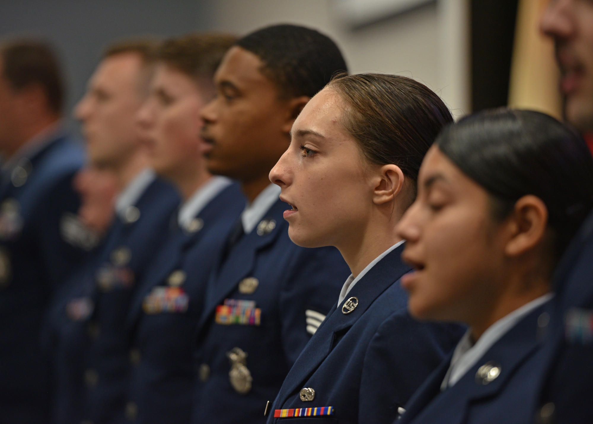 Airman Leadership School Class 22-E sings the Air Force song during the Airman Leadership School graduation at the Powell Event Center, Goodfellow Air Force Base, Texas, July 7, 2022. ALS is a five-week course designed to prepare senior airmen to assume supervisory duties through instruction in leadership, followership, written and oral communication skills, and the profession of arms. (U.S. Air Force photo by Senior Airman Ashley Thrash)