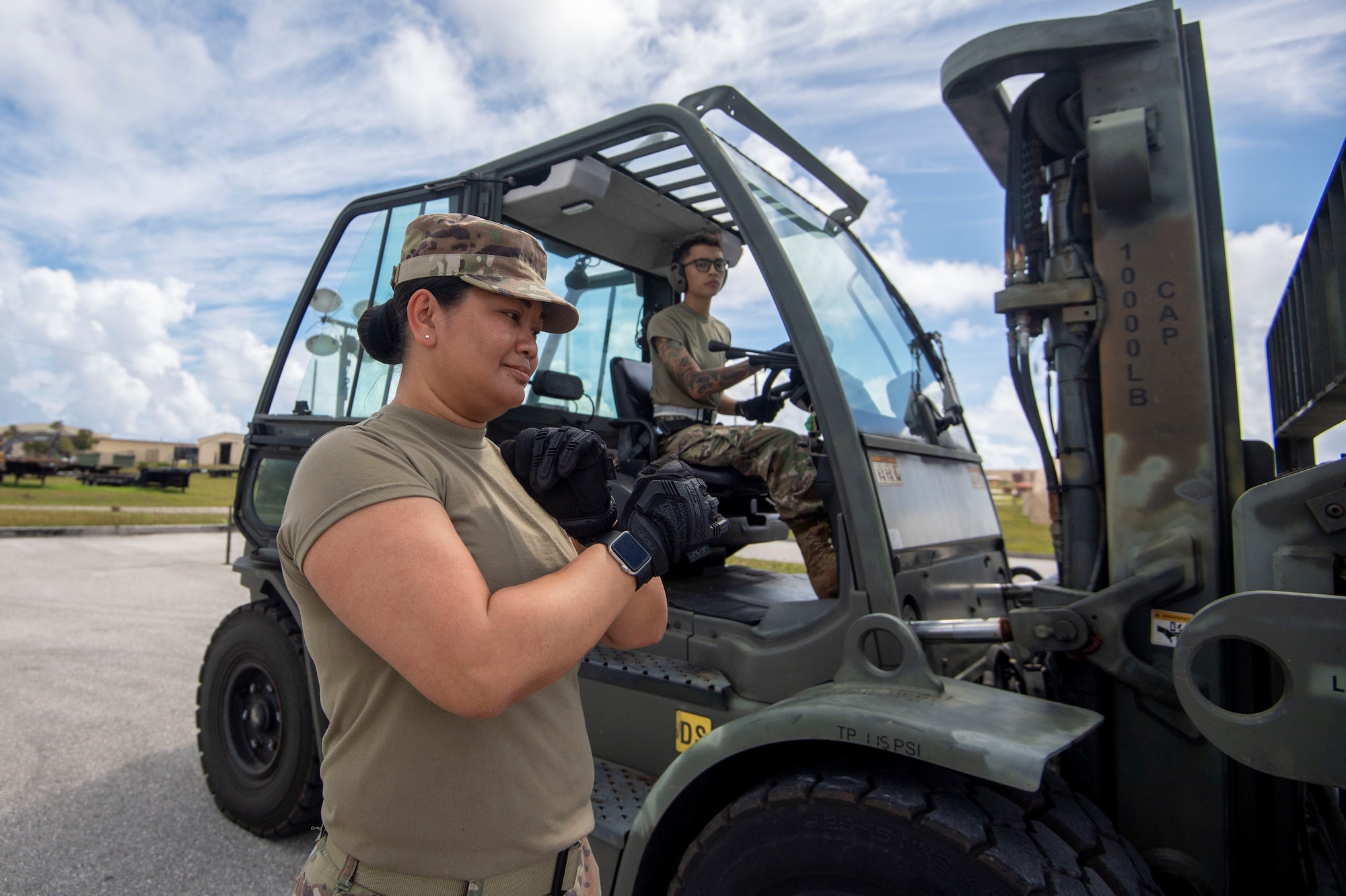 Master Sgt. Emerita Pineda spots Senior Airman Ethan So, while loading cargo onto pallet during Valiant Shield 2022, June 8, 2022 at Andersen Air Force Base, Guam.