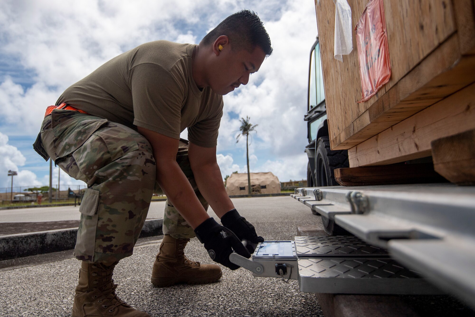 Master Sgt. Bedrick Briones positions a scale to weigh cargo during Valiant Shield 2022, June 8, 2022 at Andersen Air Force Base, Guam. Briones is a Reserve Citizen Airmen from the 44th Aerial Port Squadron.