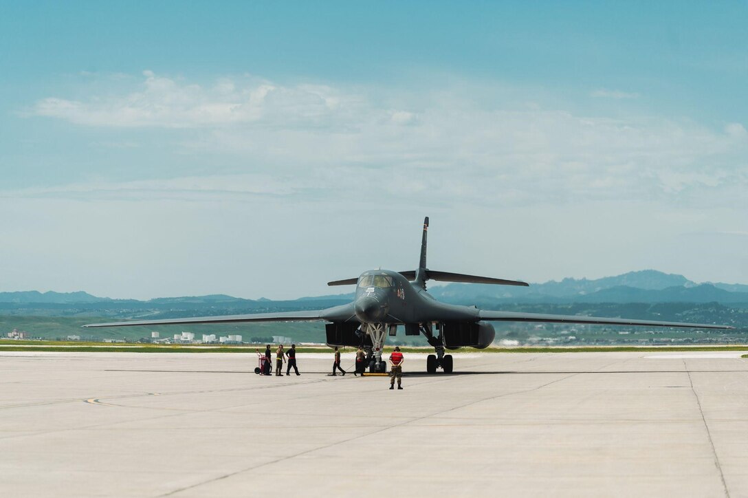 A B-1B Lancer is taxied into position by maintainers from the 28th Aircraft Maintenance Squadron at Ellsworth Air Force Base, S.D., June 29, 2022.