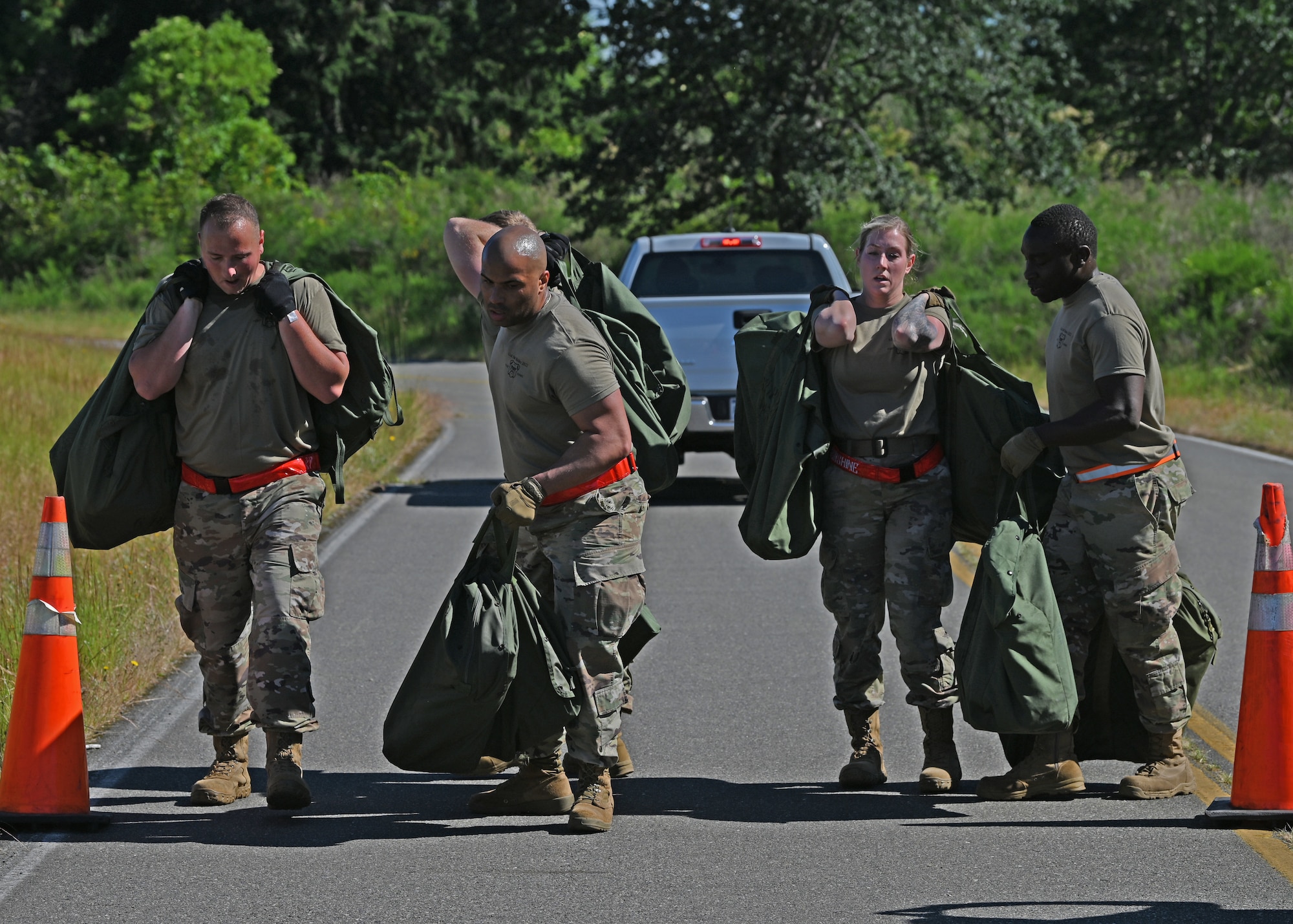 Airmen carry duffle bags.