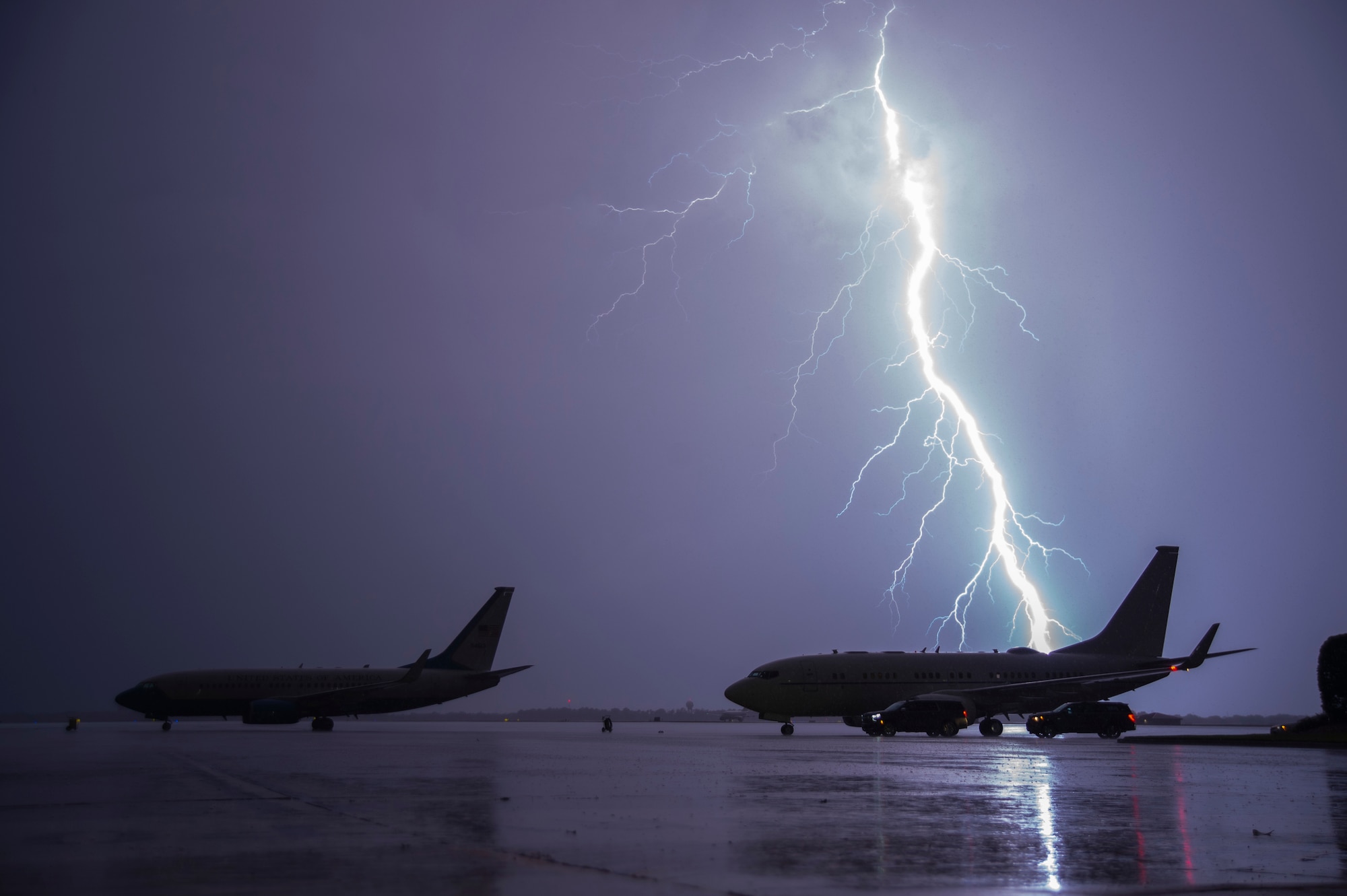 Lightning strikes behind a KC-135 Stratotanker.