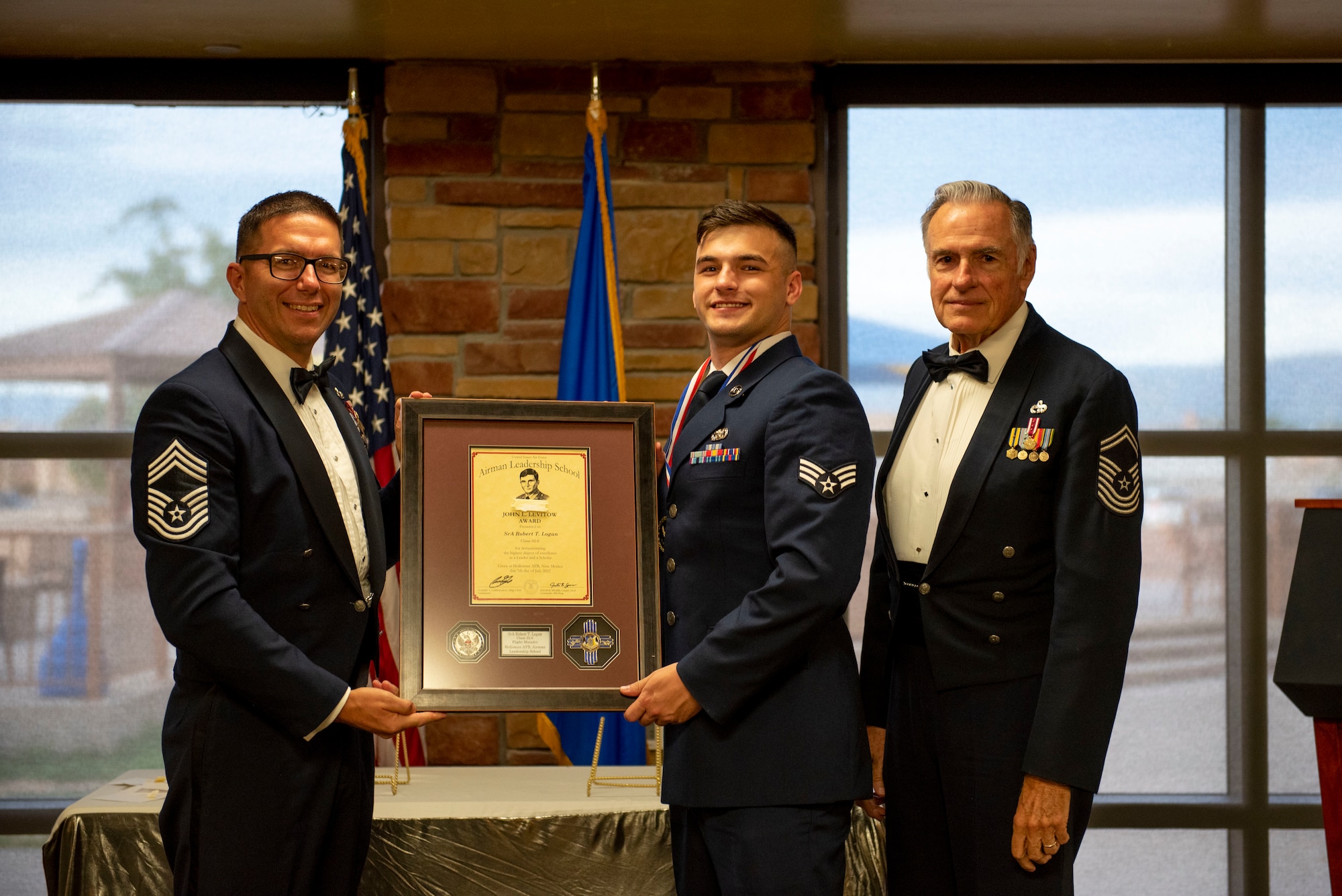 Senior Airman Robert T. Logan, Airman Leadership School graduate, accepts the John L. Levitow Award during the graduation of ALS class 22-6, July 7, 2022, on Holloman Air Force Base, New Mexico.