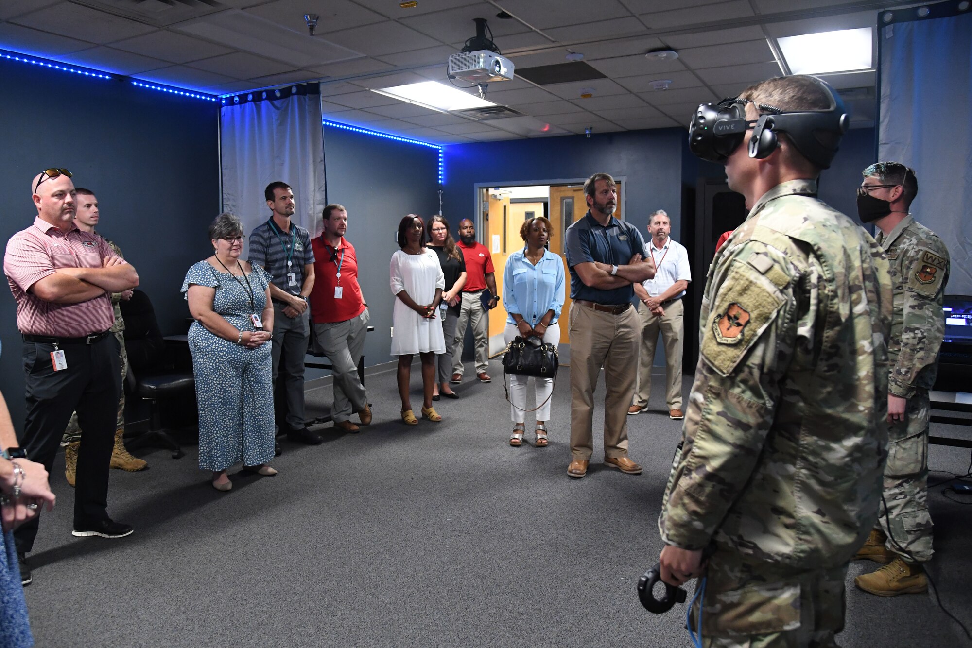 Members of the Biloxi and Jackson County School Districts administration receive a 335th Training Squadron weather training course virtual reality demonstration inside the weather training facility at Keesler Air Force Base, Mississippi, July 7, 2022. The visit also included a tour of the student dorms and the air traffic control training course. (U.S. Air Force photo by Kemberly Groue)