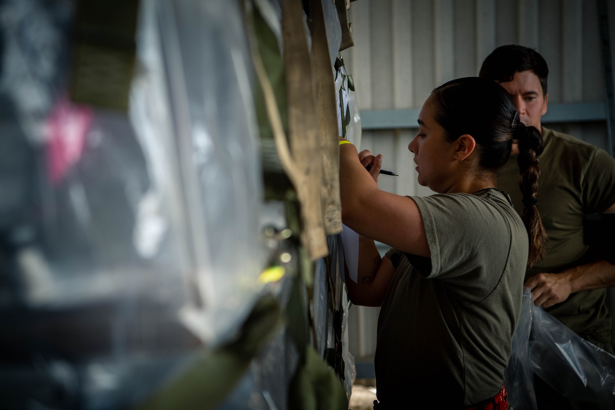 Airmen fills out documentation for a pallet.