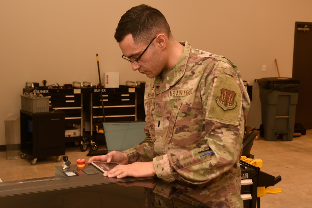 U.S. Air Force 1st Lt. Kennith McLoud, Air Force Operations Test and Evaluations Center operations research analyst, Eglin Air Force Base, Fla., checks the settings on a laser engraver, June 29, 2022, at Patrick Space Force Base, Fla. McLoud is assisting Space Launch Delta 45’s innovation center, The Forge, develop solutions for more than a dozen issues at Patrick SFB and Cape Canaveral Space Force Station. (U.S. Space Fore photo by Tech. Sgt. James Hodgman)