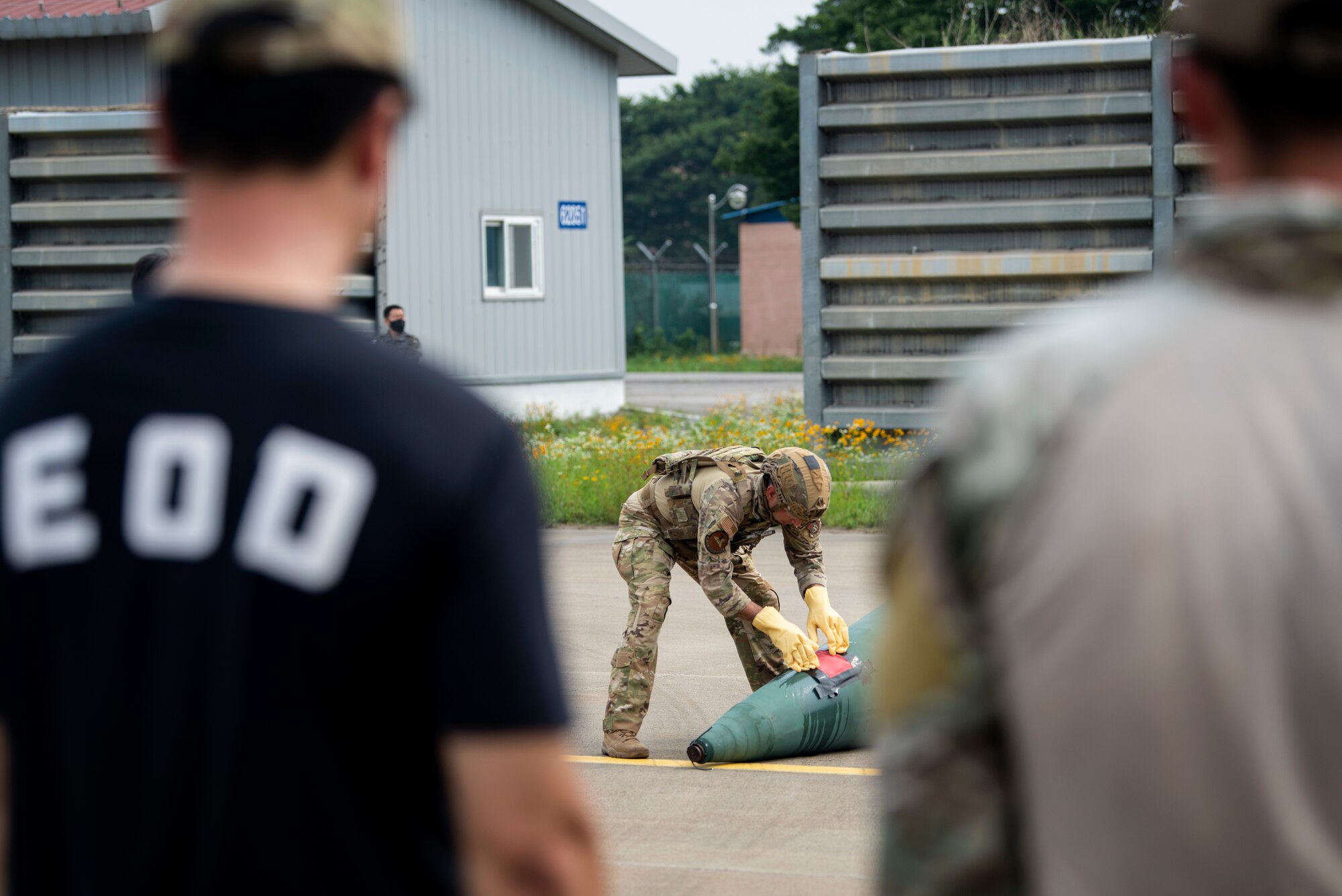 Members of the Republic of Korea Air Force, Explosive Ordnance Disposal team, observe as U.S. Air Force Staff Sgt. Michael Augustus, a 35th Civil Engineer Squadron, Explosive Ordnance Disposal technician from Misawa Air Base, Japan, responds to a mock chemical weapon disposal scenario as part of a bilateral training at Suwon Air Base, Republic of Korea, July 6, 2022