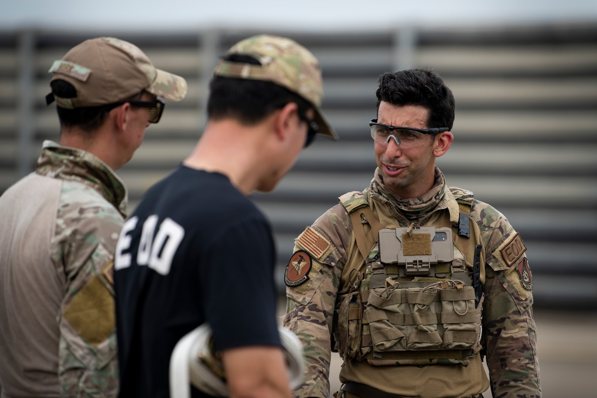 U.S. Air Force Staff Sgt. Michael Augustus, and Tech. Sgt. Derek Horn, 35th Civil Engineer Squadron, Explosive Ordnance Disposal technicians from Misawa Air Base, Japan, discuss procedures after responding to a mock chemical weapon disposal scenario at Suwon Air Base, Republic of Korea, July 6, 2022.