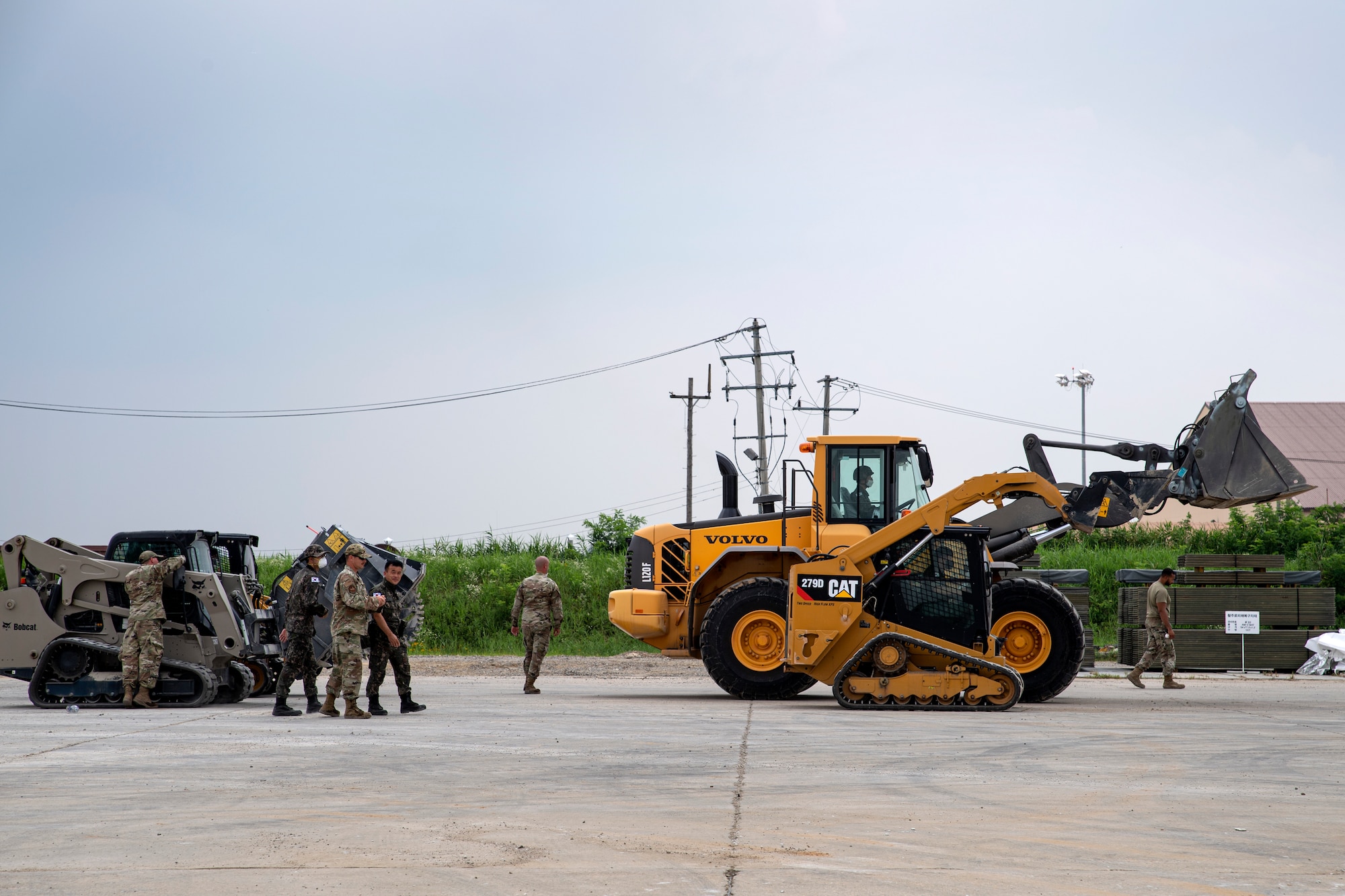 Members assigned to various sections of the 35th Civil Engineer Squadron from Misawa Air Base, Japan, and members of the Republic of Korea Air Force, prepare to conduct a runway event during a bilateral training scenario at Suwon Air Base, Republic of Korea, July 6, 2022.