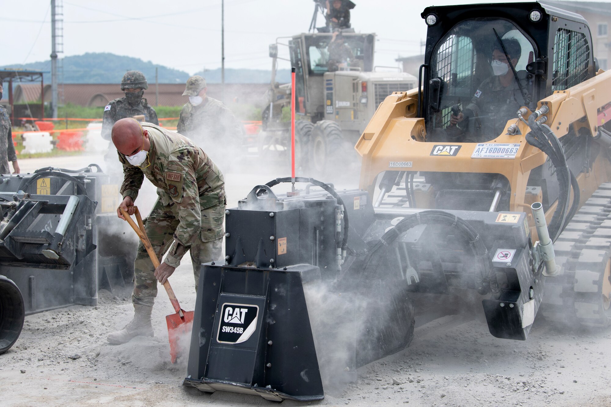 Senior Airman Ernesto Silio Cabrera, 35th Civil Engineer Squadron, water and fuels system maintenance technician from Misawa Air Base, Japan, and members of the Republic of Korea Air Force (ROKAF), practice conducting runway repairs as part of a bilateral training scenario at Suwon Air Base, Republic of Korea, July 6, 2022.