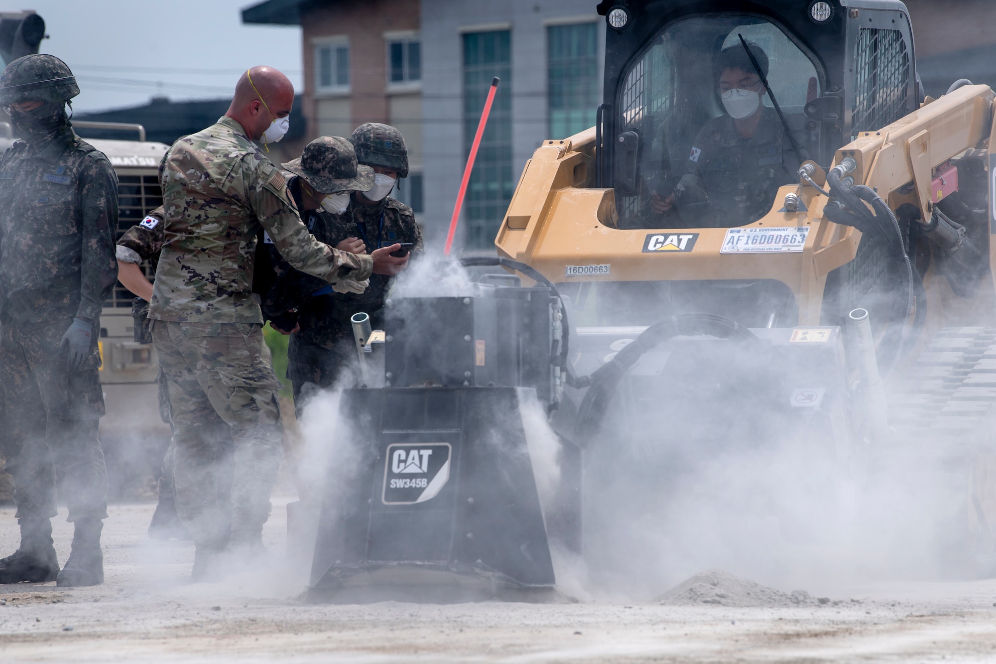 Senior Airman Ernesto Silio Cabrera, 35th Civil Engineer Squadron, water and fuels system maintenance technician from Misawa Air Base, Japan, uses a translation application on a smartphone to communicate with members of the Republic of Korea Air Force (ROKAF), while conducting runway repair as part of a bilateral training scenario at Suwon Air Base, Republic of Korea, July 6, 2022.