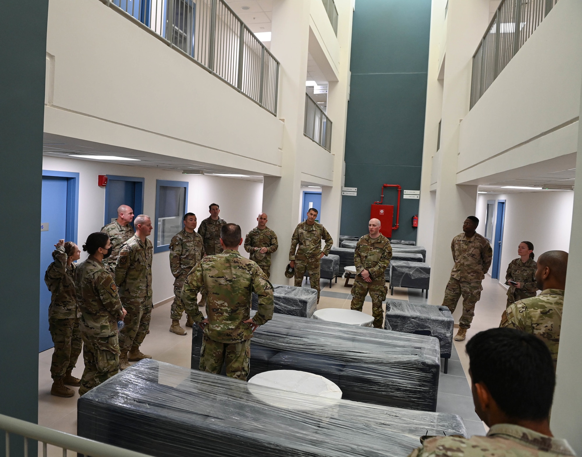 379th Air Expeditionary Wing leadership tour the interior of a newly finished dormitory July 2, 2022 at Al Udeid Air Base, Qatar. The new dorms are a part of a multi-year development project to replace aging infrastructure and improve both quality of life and safety for base tenants. (U.S. Air National Guard photo by Tech. Sgt. Michael J. Kelly)