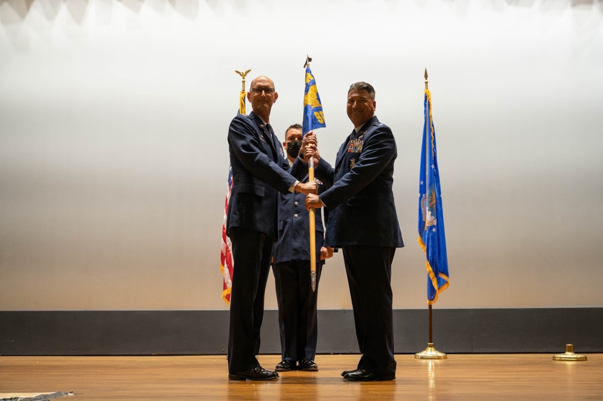 Col. Alan M. Tornay, 927th Mission Support Group commander, passes the guidon to Lt. Col. Rafael E. Perea as he takes assumption of command of the 927th Security Forces Squadron during a ceremony July 09, 2022 in the base theater at MacDill Air Force Base, Florida. Perea previously served as the commander of the 387th Expeditionary Security Forces Squadron at Dobbins Air Reserve Base, Ali Al Salem Air Base, Kuwait. (U.S. Air Force photo by Staff Sgt. Alexis Suarez)