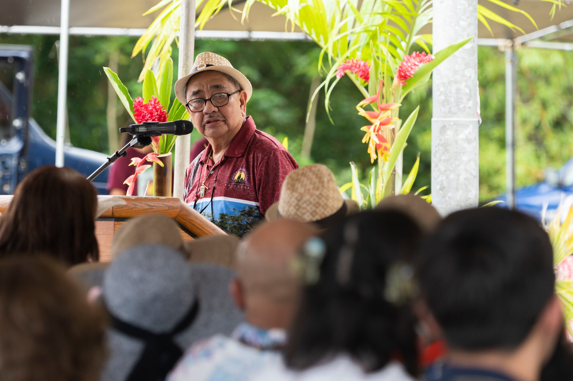 A man speaking in front of a crowd