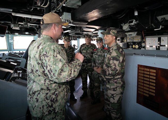 The Arleigh Burke-class guided-missile destroyer USS Porter (DDG 78) Commanding Officer Cmdr. Christopher Petro shows Brigadier General Abdellatif Malek J2 the pilot house aboard the during exercise African Lion 22, June 28, 2022.