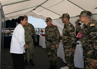 220628-N-DE439-1044 AGADIR, Morocco (June 28, 2022) Culinary Specialist 2nd Class Savanna Caballero, left, from Chicago, welcomes Brigadier General Abdellatif Malek J2 and guests to the reception hosted aboard the Arleigh Burke-class guided-missile destroyer USS Porter (DDG 78) during exercise African Lion 22, June 28, 2022.
