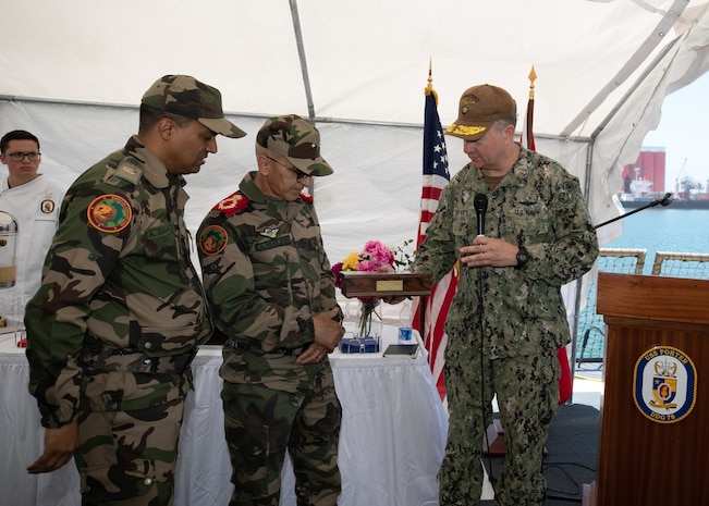 Rear Adm. Jeffery Spivey, vice commander of U.S. Sixth Fleet, presents Brigadier General Abdellatif Malek J2 with a gift during a reception aboard the Arleigh Burke-class guided-missile destroyer USS Porter (DDG 78) during exercise African Lion 22, June 28, 2022.