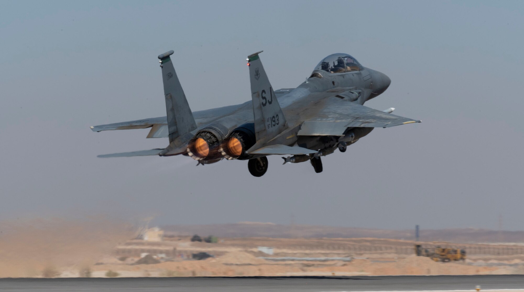 A 332d Air Expeditionary Wing F-15E Strike Eagle soars off runway with afterburners blazing during a routine training exercise at an undisclosed location in Southwest Asia, July 7, 2022. The F-15E is a dual-role fighter designed to perform air-to-air and air-to-ground missions with an array of avionics and electronics systems that give it the capability to fight at low altitude, day or night and in all weather. (U.S. Air Force photo by Technical Sgt. Jeffery Foster)
