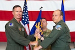 U.S. Air Force Col. John Galloway, 495th Fighter Group commander, left, hands a guidon to Lt. Col. Daniel O'Neal, F-16 fighter pilot with the 495th Fighter Group, activating the 306th Fighter Squadron July 8, 2022, at the 177th Fighter Wing, Egg Harbor Township, New Jersey. The squadron was activated as part of the Air Force’s Total Force Integration, helping to maintain the combat readiness of Air National Guard and active-duty pilots.