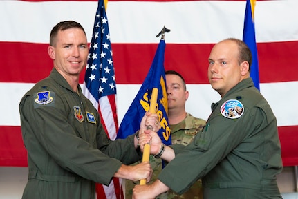 U.S. Air Force Col. John Galloway, 495th Fighter Group commander, left, hands a guidon to Lt. Col. Daniel O'Neal, F-16 fighter pilot with the 495th Fighter Group, activating the 306th Fighter Squadron July 8, 2022, at the 177th Fighter Wing, Egg Harbor Township, New Jersey. The squadron was activated as part of the Air Force’s Total Force Integration, helping to maintain the combat readiness of Air National Guard and active-duty pilots.