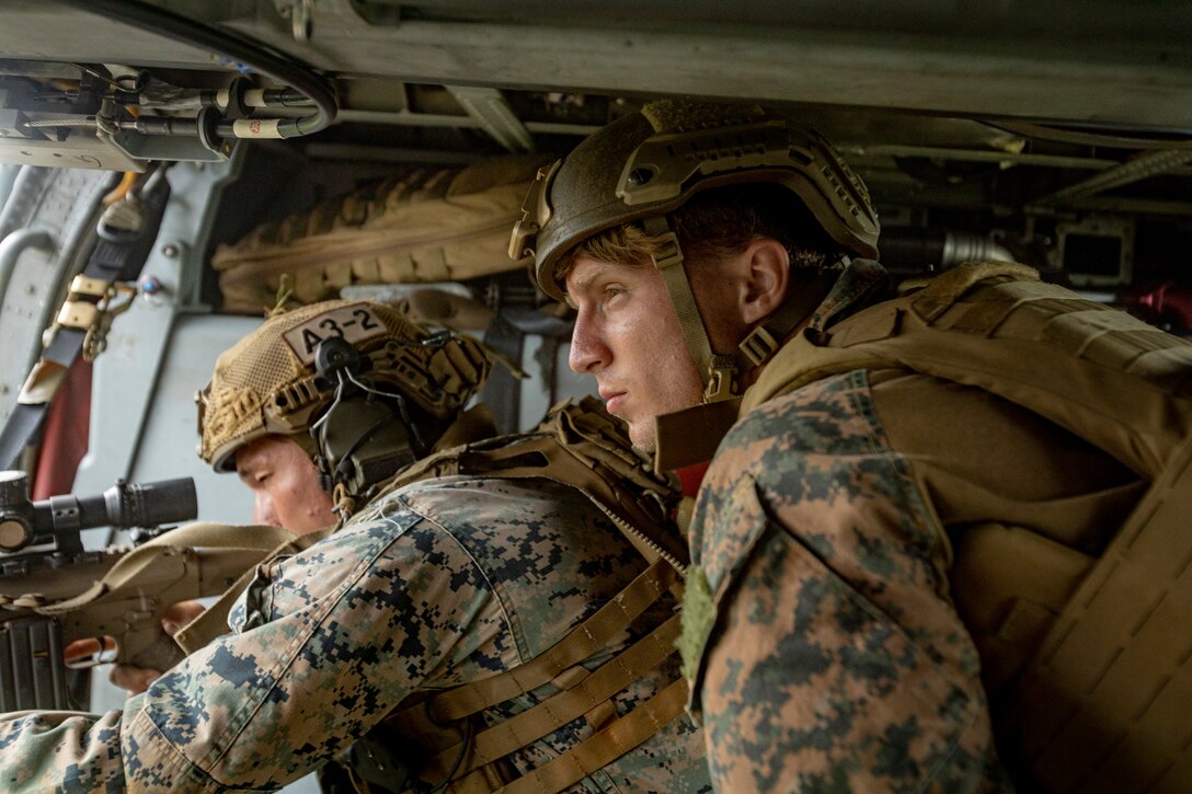 U.S. Marine Corps Sgt. Trevor Hancock, a rifleman with 3rd Battalion, 2nd Marine Regiment, 2nd Marine Division, provides direction to a Marine for an aerial sniper training during an Urban Sniper Course on Camp Schwab, Okinawa, Japan, June 15, 2022. The aerial sniper training was led by Marines and military contractors with the Expeditionary Operations Training Group to enhance participating Marines' skills in urban environments through precision fire and engaging simulated targets from an aircraft.