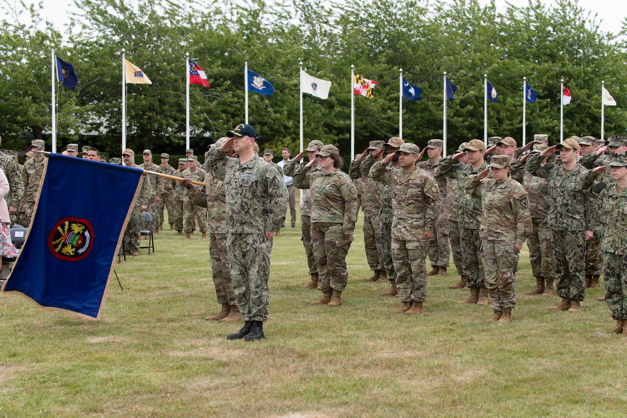 Members of the Joint Intelligence Operations Center Europe Analytic Center present a final salute during a change of command ceremony at Royal Air Force Molesworth, England, July 7, 2022. The change of command ceremony is rooted in military history dating back to the 18th century representing the relinquishing of power from one officer to another. (U.S. Air Force photo by Senior Airman Jennifer Zima)