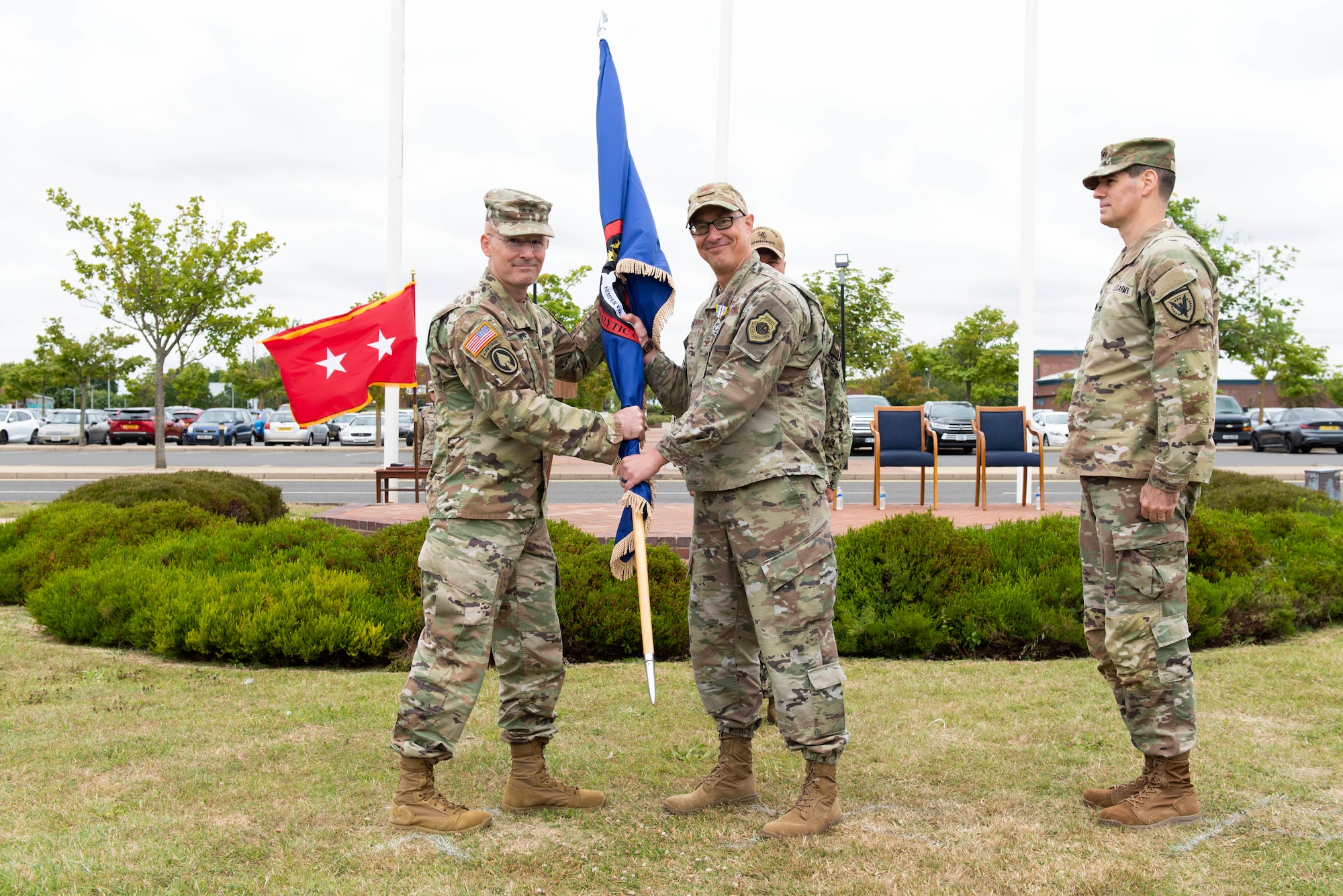 U.S. Air Force Col. Abraham Jackson, right, U.S. European Command Joint Intelligence Operations Center Europe Analytic Center outgoing commander, relinquishes command during the JIOCEUR Analytic Center change of command ceremony at Royal Air Force Molesworth, England, July 7, 2022. The change of command ceremony is rooted in military history dating back to the 18th century representing the relinquishing of power from one officer to another. (U.S. Air Force photo by Senior Airman Jennifer Zima)