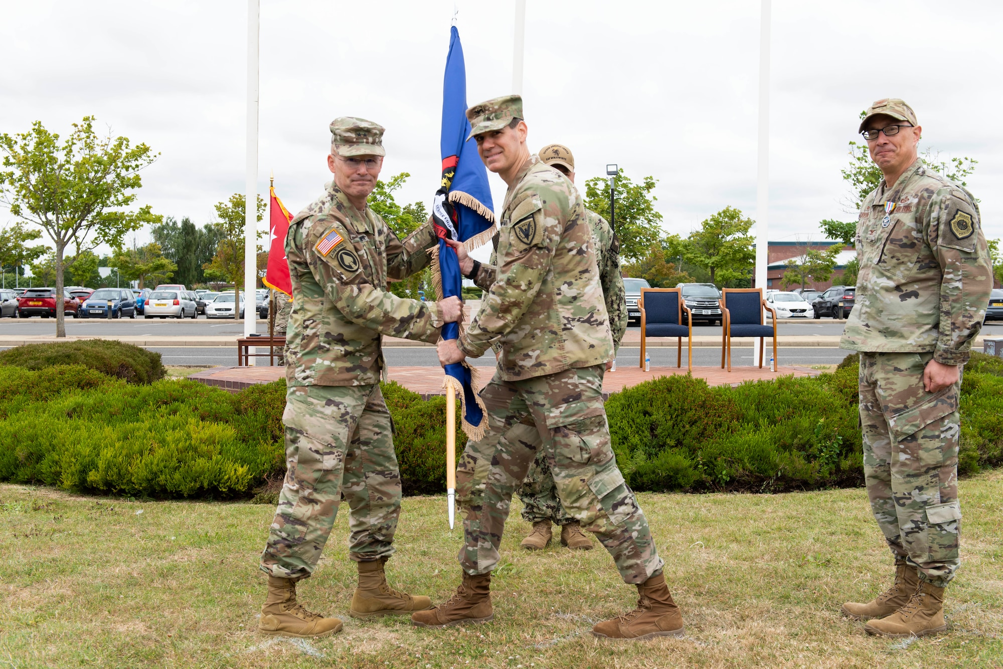 U.S. Army Col. Steven Lacy, right, U.S. European Command Joint Intelligence Operations Center Europe Analytic Center incoming commander, assumes command during the JIOCEUR Analytic Center change of command ceremony at Royal Air Force Molesworth, England, July 7, 2022. The change of command ceremony is rooted in military history dating back to the 18th century representing the relinquishing of power from one officer to another. (U.S. Air Force photo by Senior Airman Jennifer Zima)