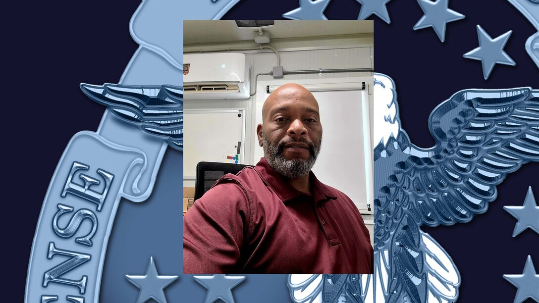 Man posing at desk.