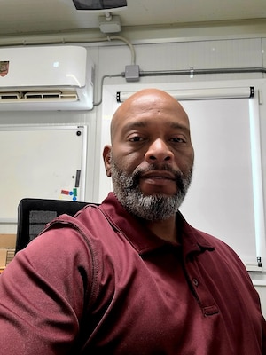 Man posing at desk.