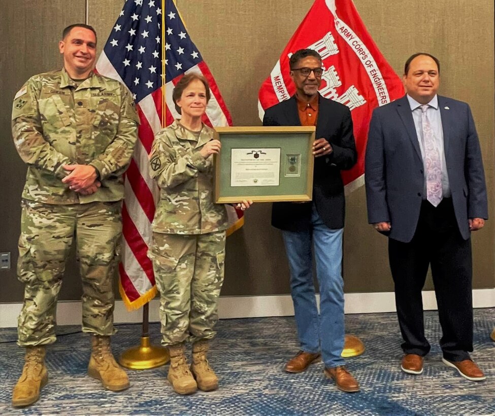 IN THE PHOTO, Mississippi Valley Division Commander Maj. Gen. Diana Holland (second from left) presents Civil Hydraulic Engineer and recent retiree Don Davenport (third from left) with a Commander's Civilian Service Award during the Memphis District Townhall Meeting, June 1. Memphis District Commander Lt. Col. Robert Green (far left) and Deputy District Engineer for Programs and Project Management Donny Davidson (far right) joined the commander in congratulating Davenport on his retirement from service after an astounding 40 years with the Memphis District.
