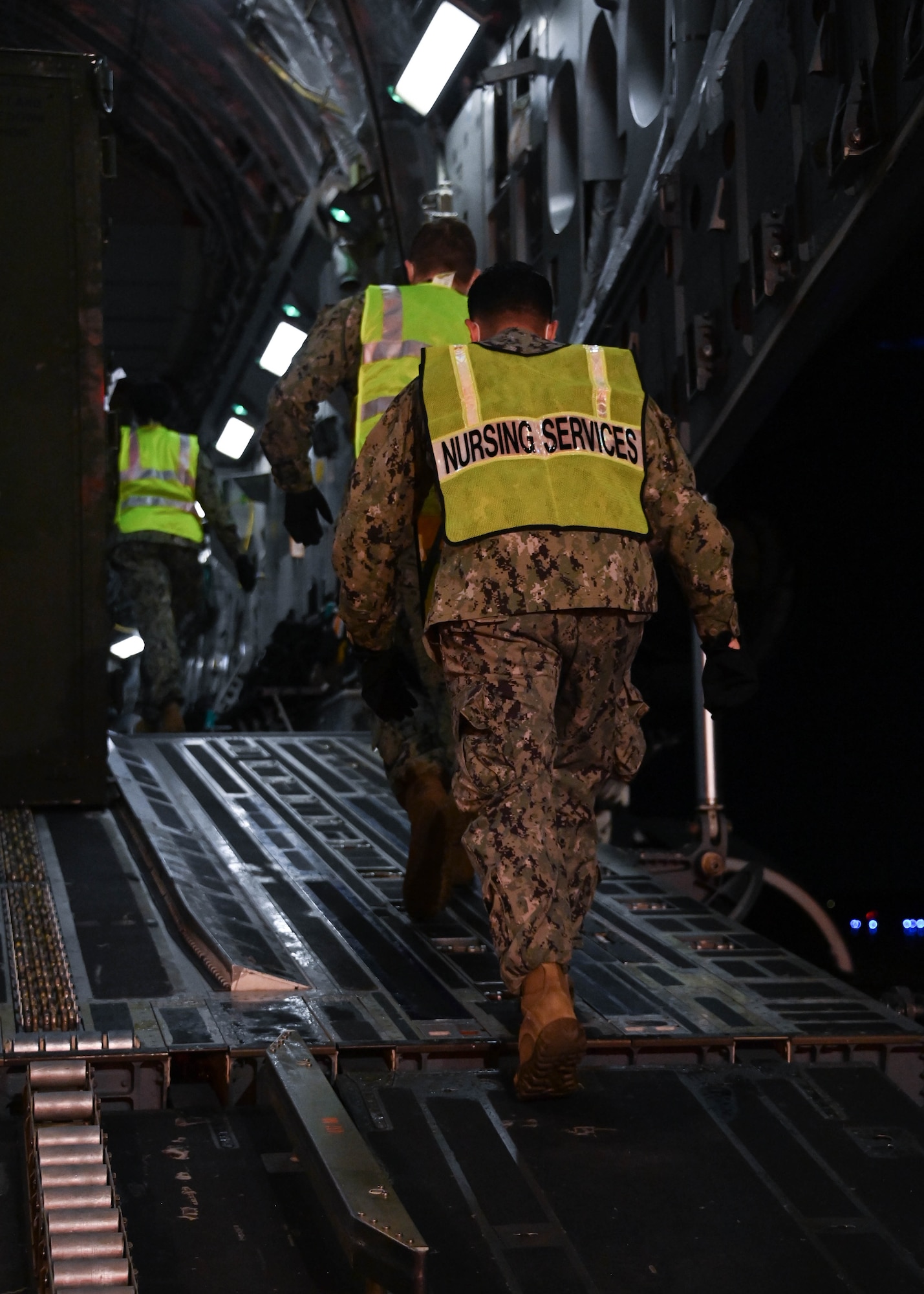 Corpsmen from Walter Reed National Military Medical Center prepare to transport patients from a C-17 Globemaster 3 to the En-Route Patient Staging Facility at Joint Base Andrews, Md., July 7, 2022.