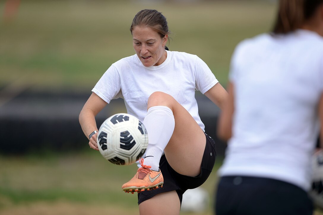 Women play soccer.