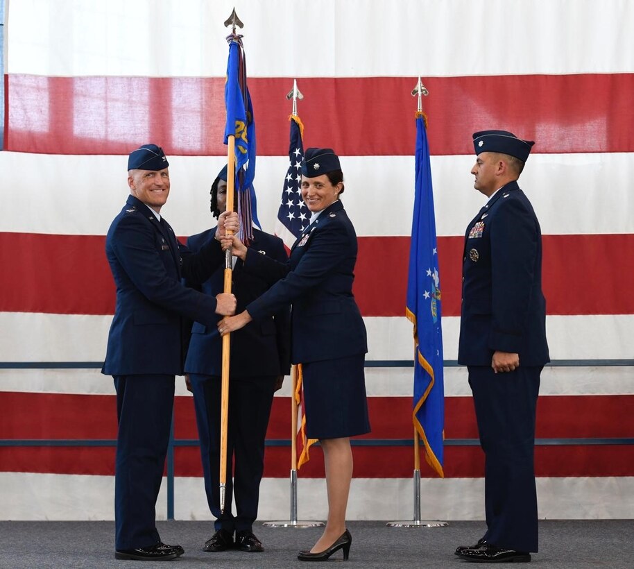 Col. Derek Oakley, the 28th Operations Group commander, relinquishes Lt. Col. Kristina Ellis, the outgoing 28th Operations Support Squadron commander, of her command of the 28th Operations Support Squadron at Ellsworth Air Force Base, S.D., July 08, 2022.