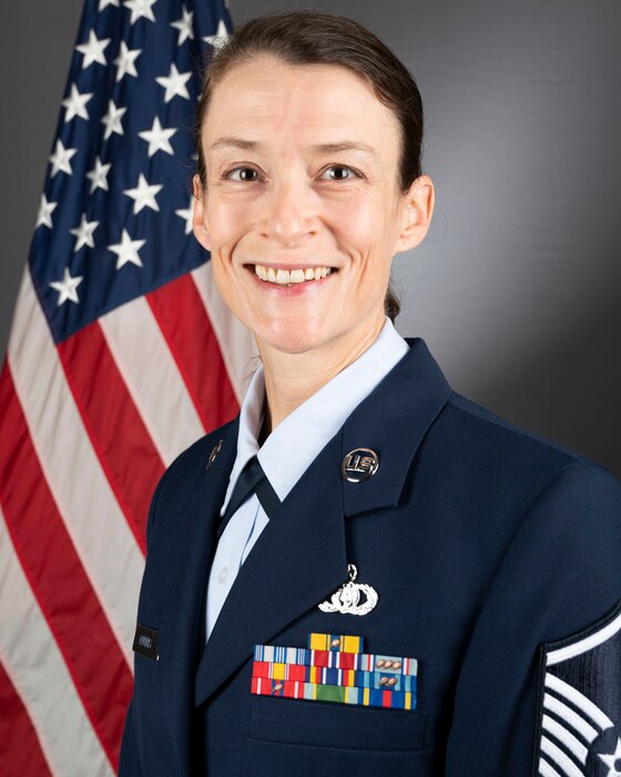 Official Headshot of MSgt Anne Epperly in front of the American flag. She is wearing the blue service dress uniform.