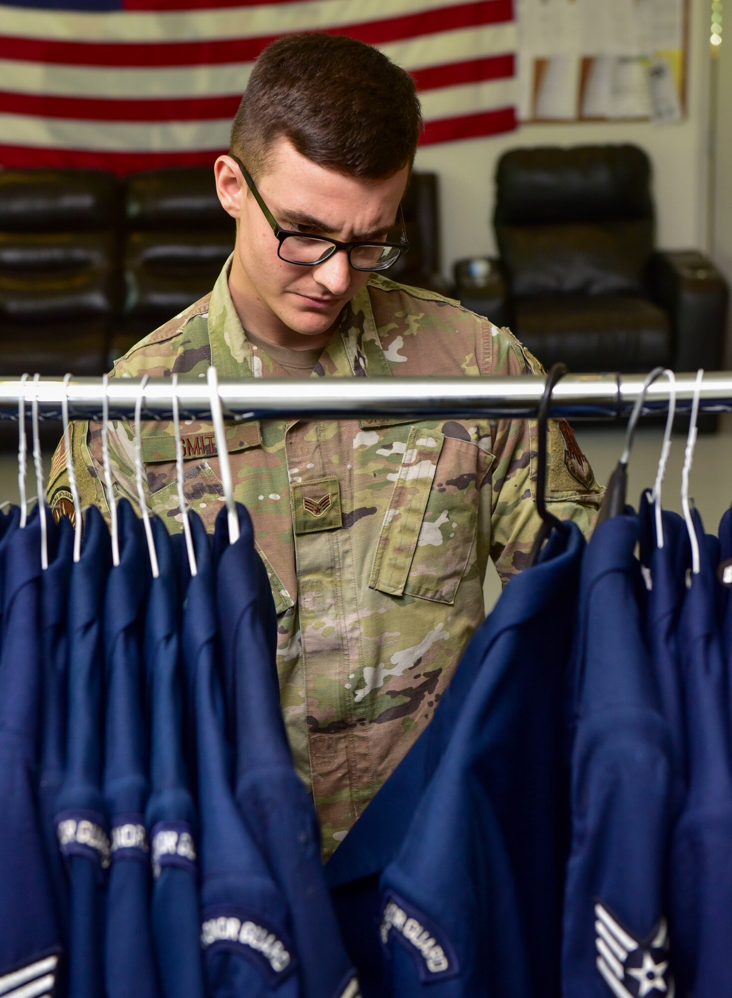 Senior Airman Noah Smith, 4th Equipment Maintenance Squadron aircraft structural maintenance , inspects uniforms at Seymour Johnson Air Force Base, North Carolina, July 7, 2022. Smith is also a member of the base honor guard and ensures base honor guard Airmen are promoting U.S. Air Force heritage, professionalism and dress and appearance. (U.S. Air Force photo by Senior Airman Taylor Hunter)