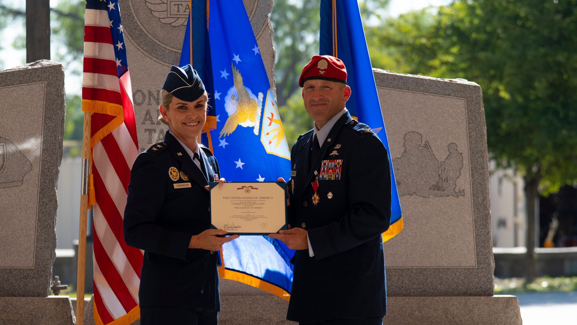 U.S. Air Force Maj. Gen. Michele Edmondson (left), 2nd Air Force commander and presiding officer, presents the Legion of Merit to Col. Mason Dula (right), outgoing Special Warfare Training Wing commander during the SWTW change of command ceremony at Joint Base San Antonio-Chapman Training Annex, Texas, July 11, 2022.