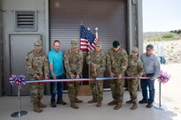 Soldiers and cmunity members cut a ribbon