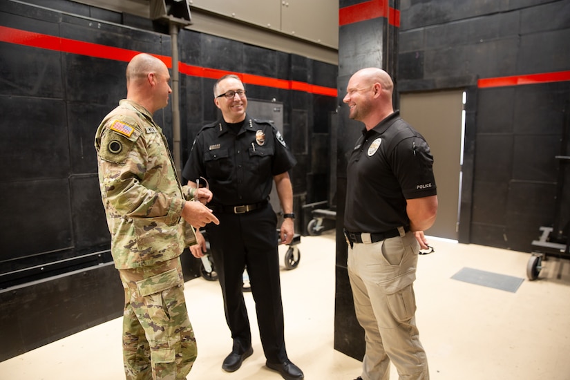 Left to right: Command Sgt. Maj. Spencer Nielsen, senior enlisted leader, Utah National Guard; Troy Carr, Herriman City Chief of Police; and Sgt. Josh Jennings, Herriman City Police tour the Special Operations Forces Live-Fire Shoot House (SOF LFSH) after the ribbon-cutting ceremony at Camp Williams, Utah, July 11, 2022.