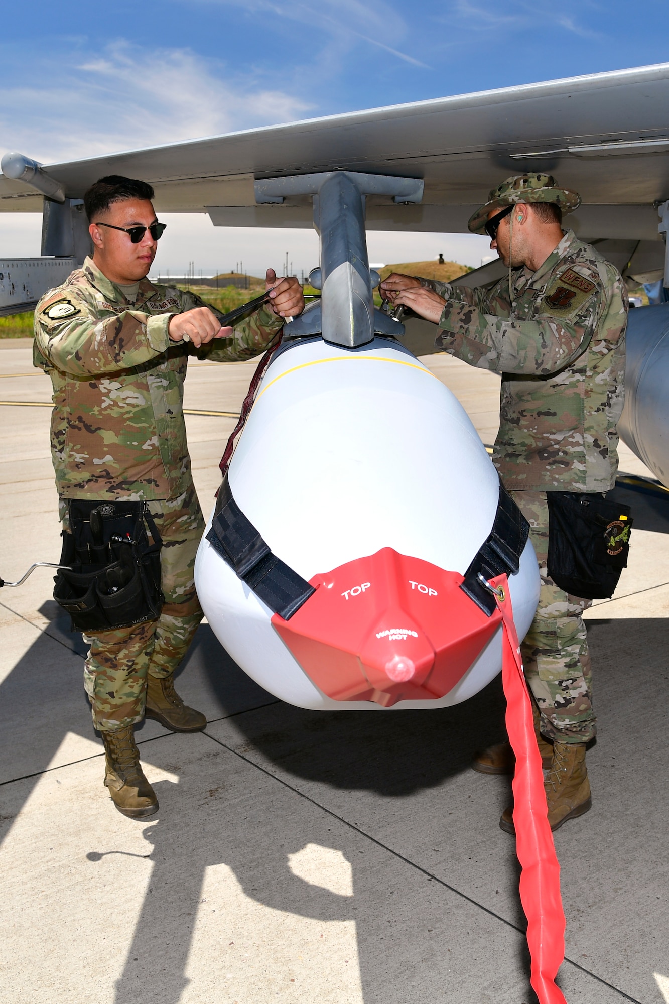 Airmen with the Air National Guard Air Force Reserve Command Test Center (AATC) load a Joint Air-to-Surface Standoff Missile (JASSM) on a pre-block F-16 for a test launch. This is the first time a JASSM has been launched from a pre-block F-16, a model flown by Air National Guard and Air Force Reserve units.