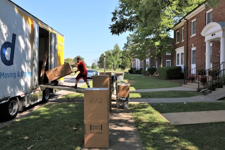 Moving boxes in front of house