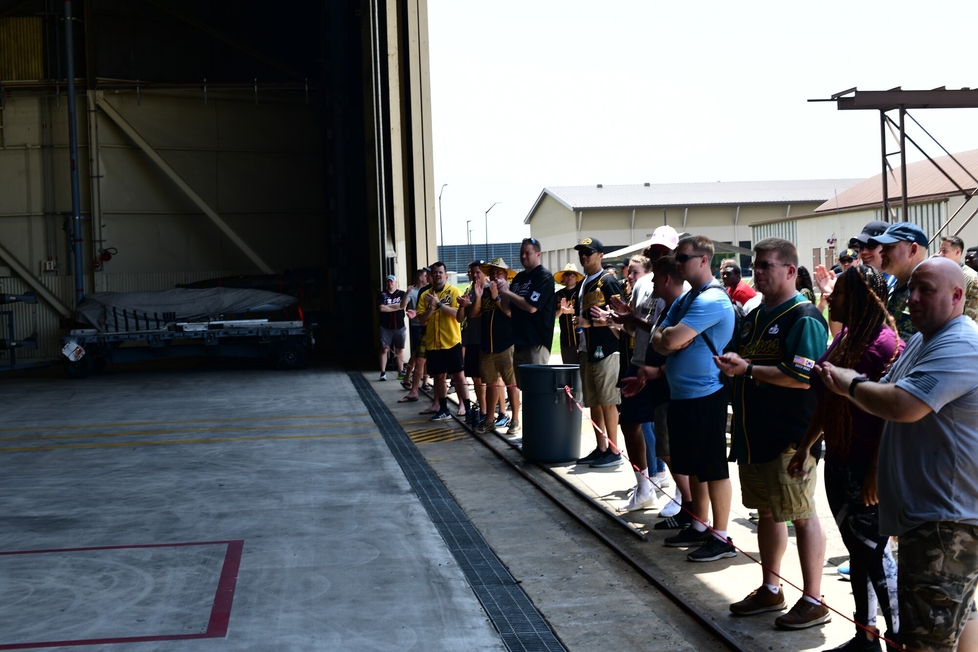 People standing at hangar entrance.