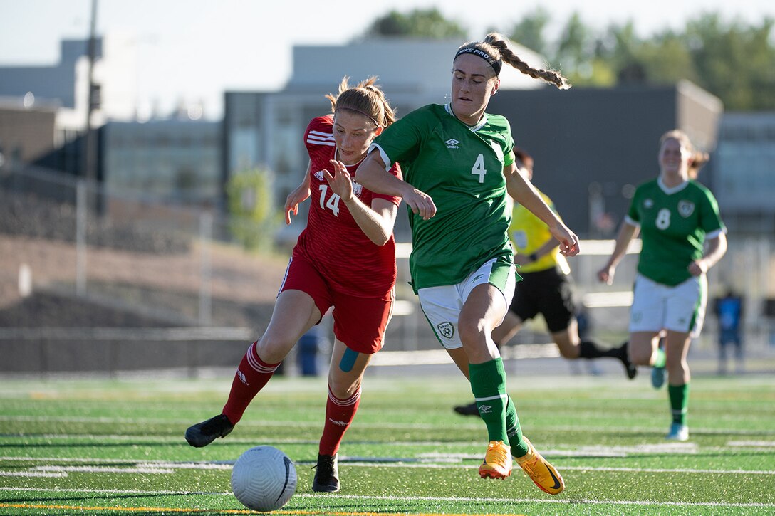 Germany’s OR-4 Sonja Bartoshek, left, and Ireland’s Pte. Shannon Thomas battle for a ball during the during the second round of opening night for the  13th CISM (International Military Sports Council) World Military Women’s Football Championship in Meade, Washington July 11, 2022.  Germany beat Ireland 3-0. (DoD photo by EJ Hersom)